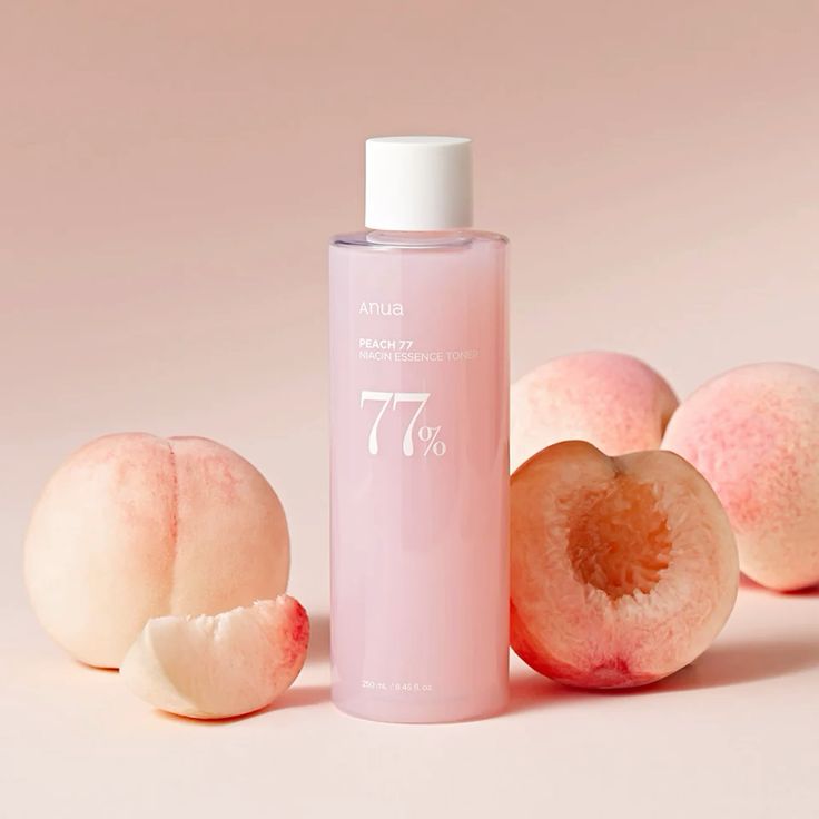 Pink bottle labeled '77%' with peaches on a light pink background